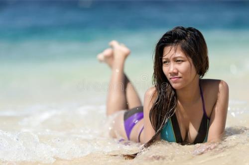 filipina-woman-lying-sand-seashore-sunny-day-39342691