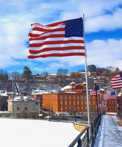 Flag - On bridge over snow covered river