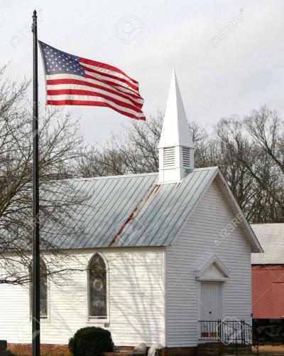 6337841-american-flag-in-front-of-an-old-church