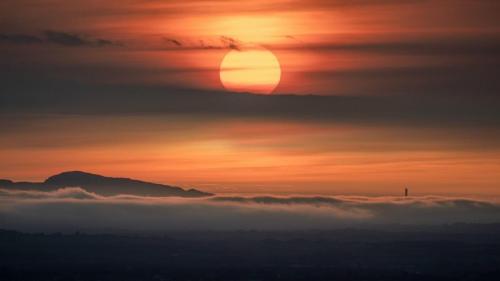 Mynydd Twr (Holyhead Mountain) sunset above inversion clouds. Shot from Rhosgadfan in Wales
