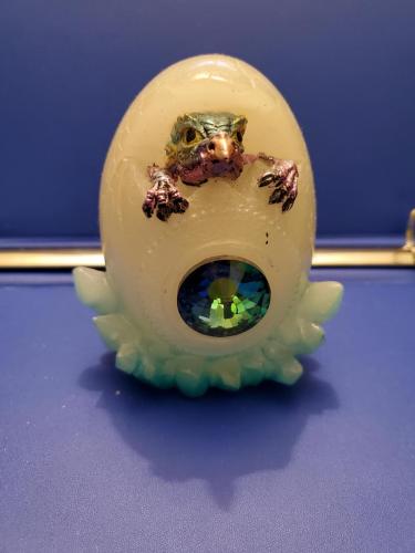 blue pink baby dragon coming out of egg