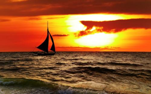 Yacht at sea on sunset background