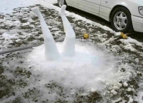 Snow-Ice Art, Man -- Snowman Head first into Cement Driveway