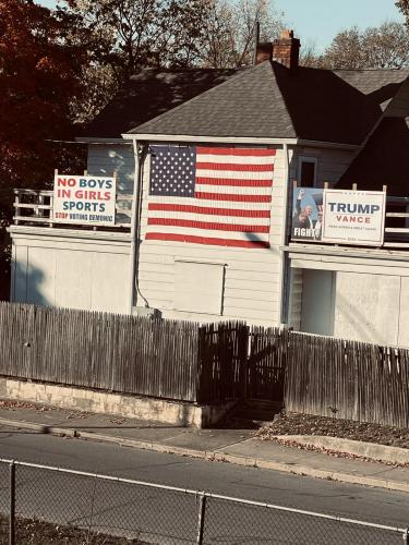 Richard Justman, Signs, Highway, USA Flag, Trump Assassination -- 'No Boys in Girls Sports, Stop Voting Demonic'; 'Trump Vance. MAGA FIGHT!'