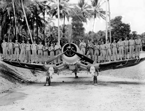 The Black Sheep Squadron pose on the wings of Corsair aircraft at Vella Lavella, December, 1943.