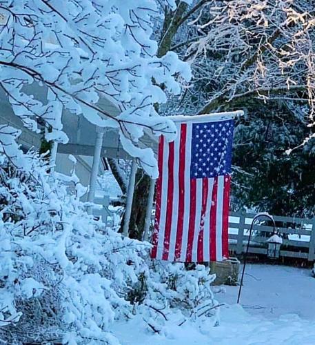 Flag - Hanging from snowy porch